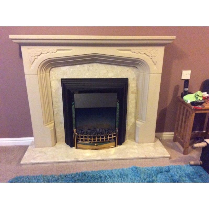 Fire Place mock stone and marble with electric coal effect fire.