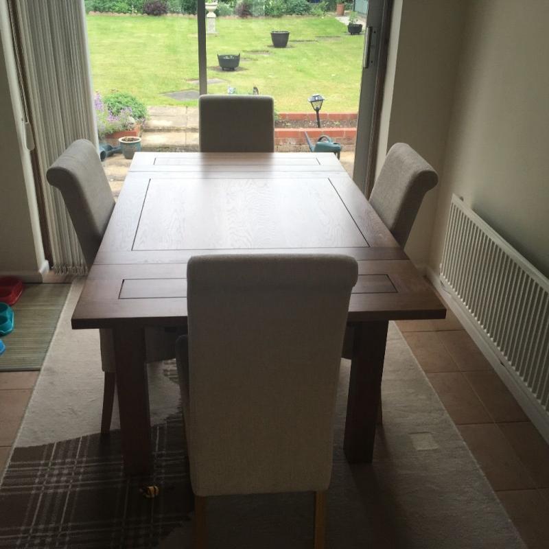 Solid oak extending dining table and chairs