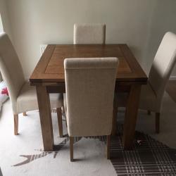 Solid oak extending dining table and chairs