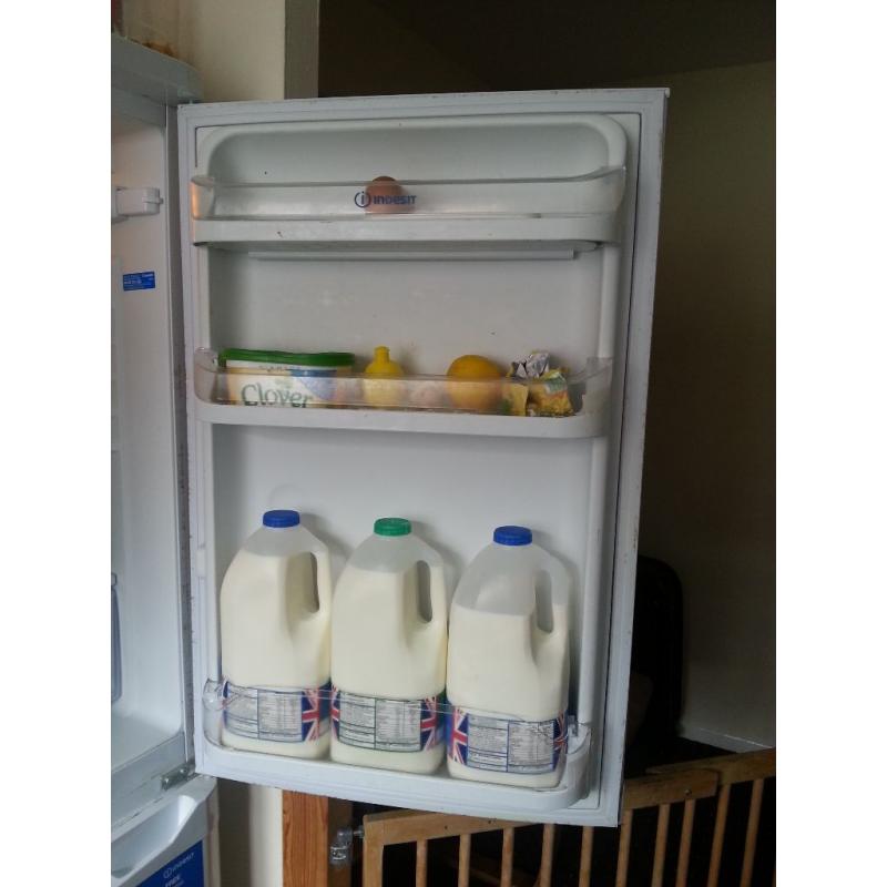 Tall Indesit fridge-freezer.