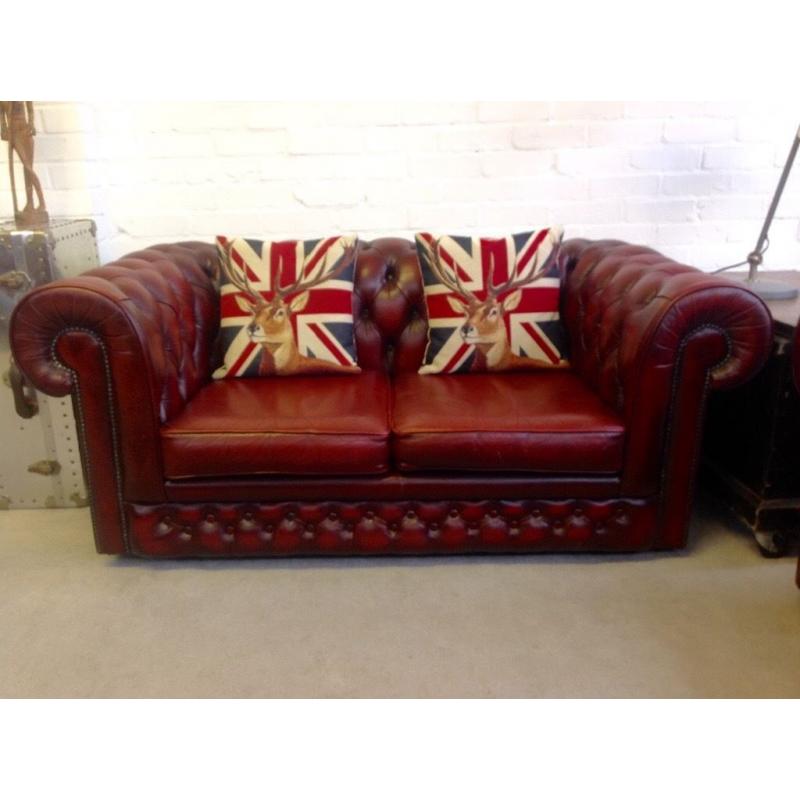 2 seater oxblood Chesterfield sofa. Can deliver .
