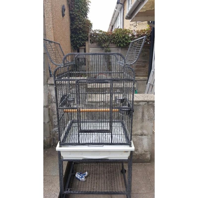 Black metal birdcage on stand with shelf