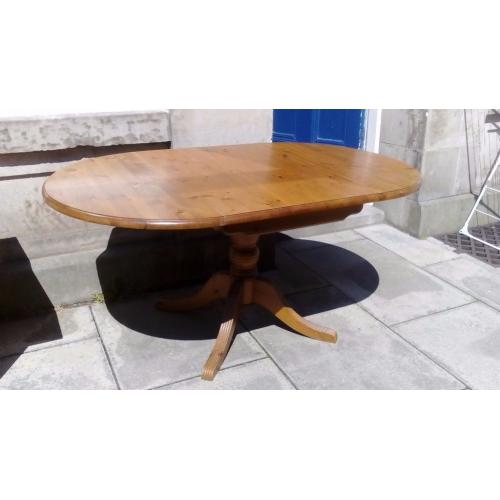 Pine drop leaf dining table with pedestal leg .