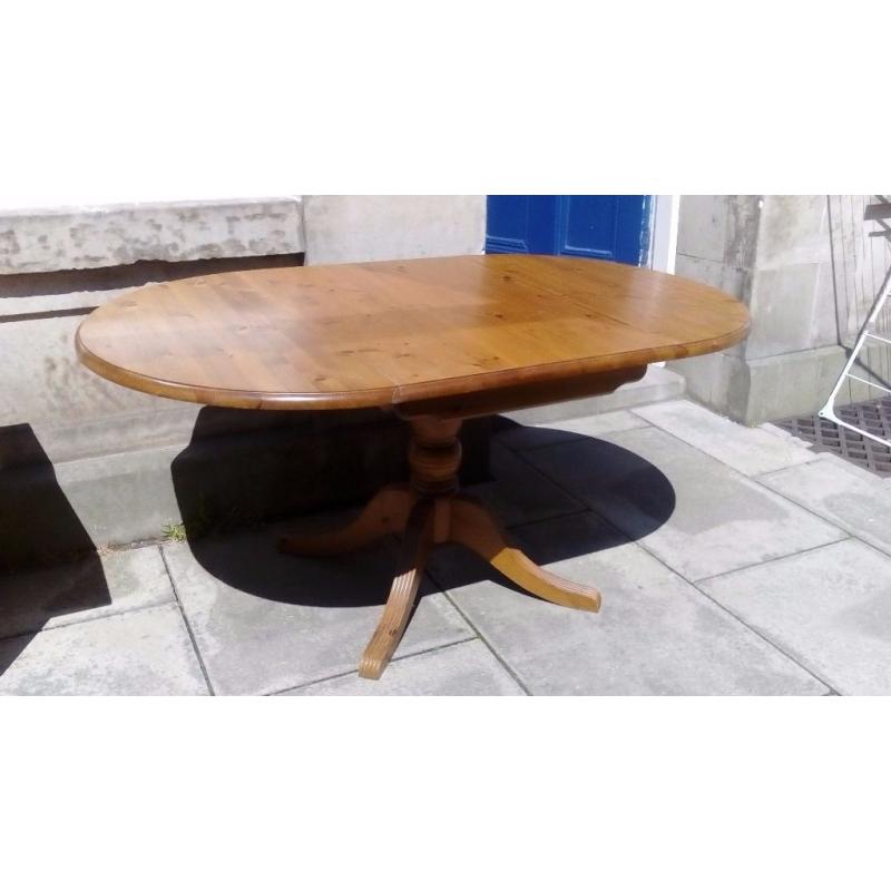 Pine drop leaf dining table with pedestal leg .