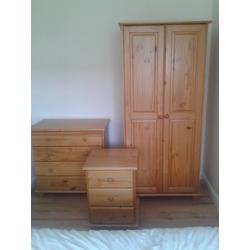 Three piece solid pine bedroom suite-wardrobe, chest of drawers, bedside cabinet.Excellent condition