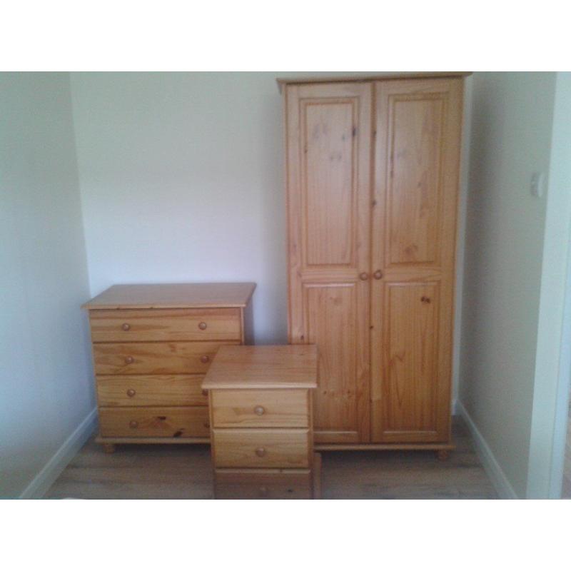 Three piece solid pine bedroom suite-wardrobe, chest of drawers, bedside cabinet.Excellent condition