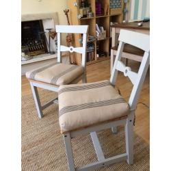 Two dining chairs with cushions