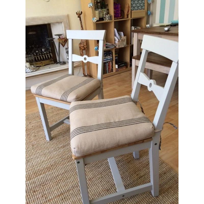 Two dining chairs with cushions