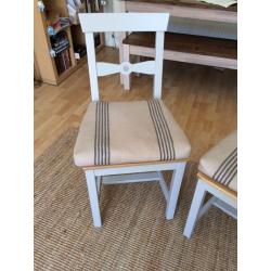 Two dining chairs with cushions
