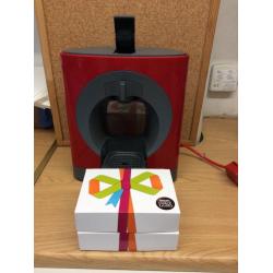 Nescafé Dolce Gusto Coffee Machine in red with 2 boxes of assorted pods
