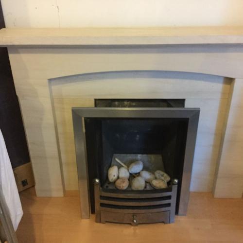 Limestone fireplace and gas fire