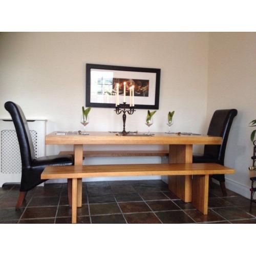 Beautiful solid oak refectory dining table, benches and chairs. Seats 8.