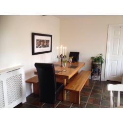 Beautiful solid oak refectory dining table, benches and chairs. Seats 8.