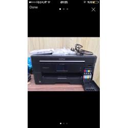 Brother MCF-J625DW A3 printer, with ink cartridges, connectors and more.