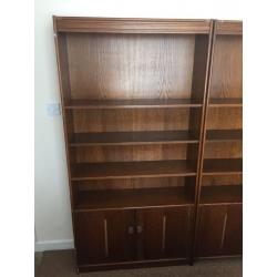 Two oak veneer bookcases with cupboards