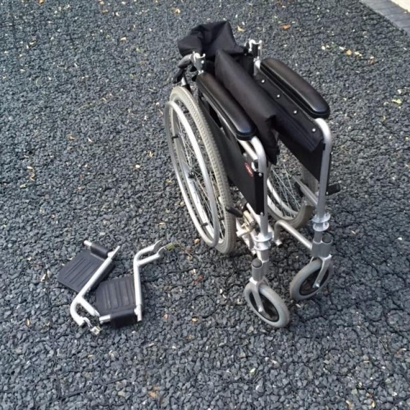 Enigma self propel wheelchair with right leg elevating foot rest