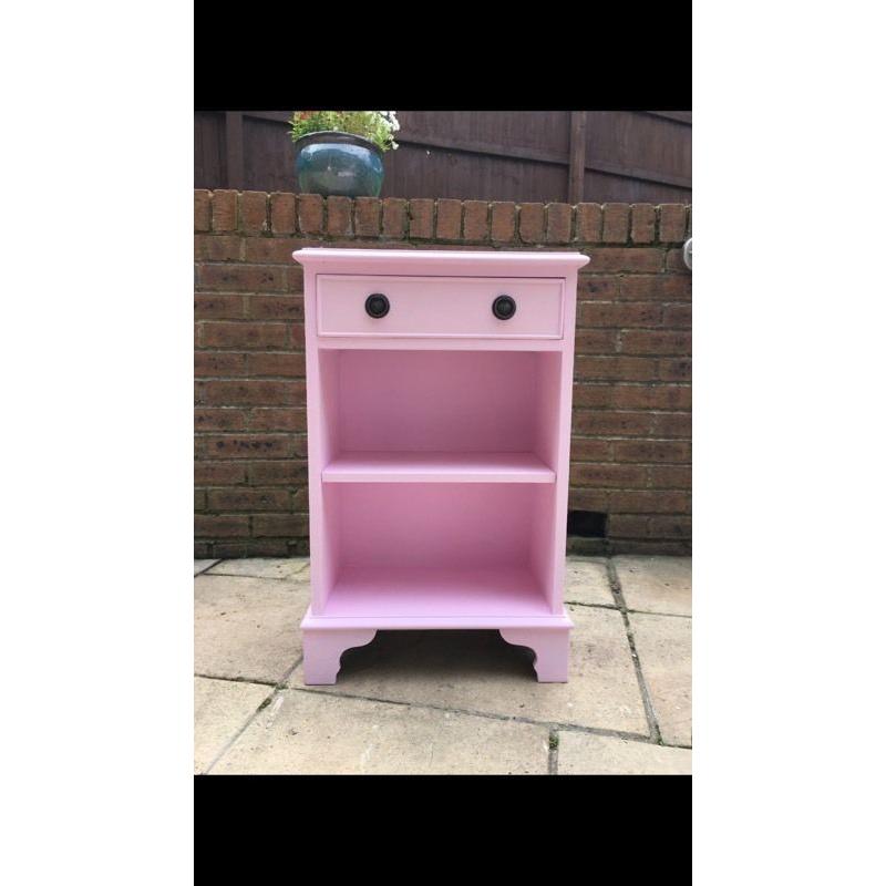Pink cabinet with a draw and shelf