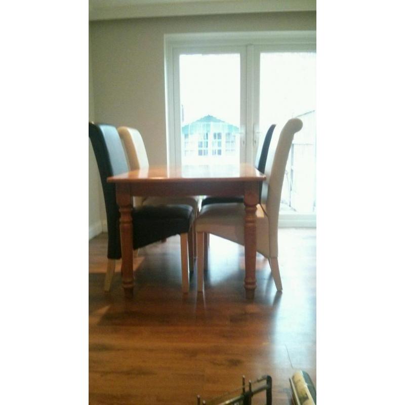 Table & 4 chairs, Solid wood table with 4 roll back leather look chairs