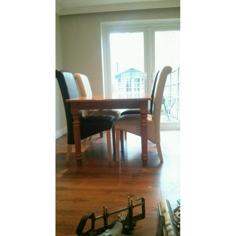 Table & 4 chairs, Solid wood table with 4 roll back leather look chairs