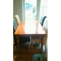 Table & 4 chairs, Solid wood table with 4 roll back leather look chairs