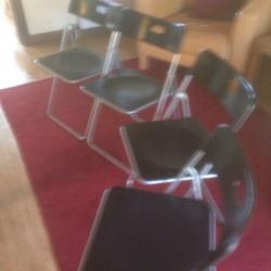 4 black & silver folding chairs.