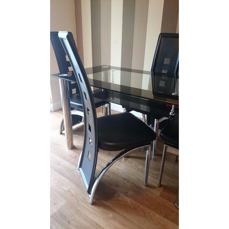 Black glass top dining table and 4 chairs