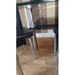Black glass top dining table and 4 chairs
