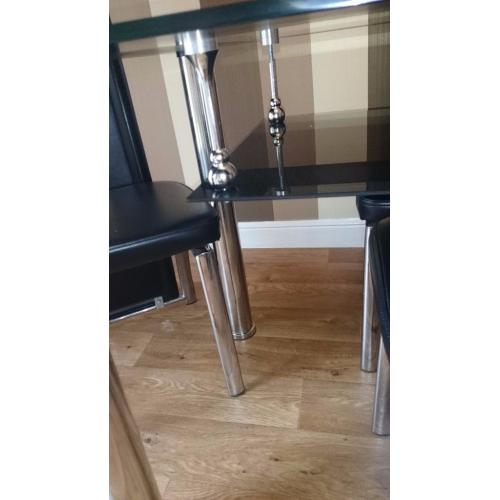 Black glass top dining table and 4 chairs