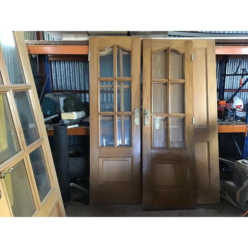 Double doors with glass and handles and a bathroom door