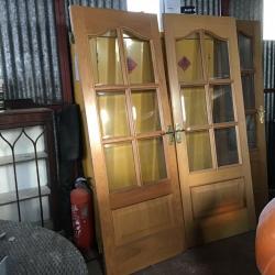 Double doors with glass and handles and a bathroom door