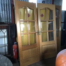 Double doors with glass and handles and a bathroom door