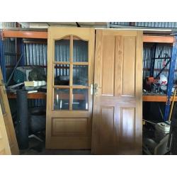 Double doors with glass and handles and a bathroom door