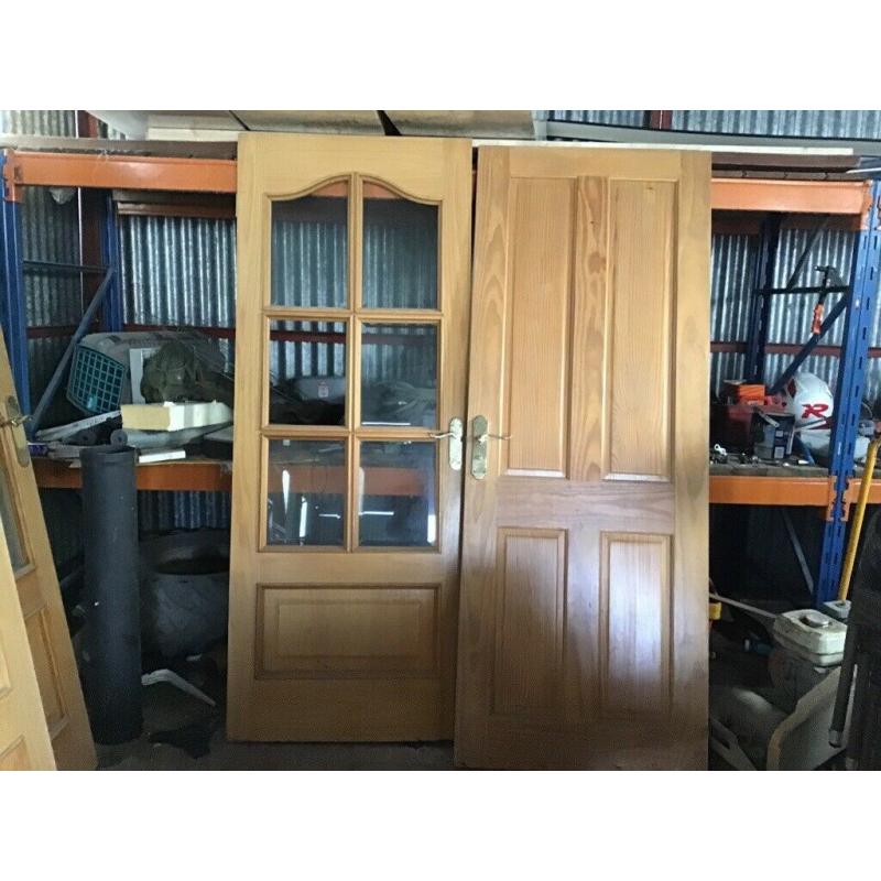 Double doors with glass and handles and a bathroom door