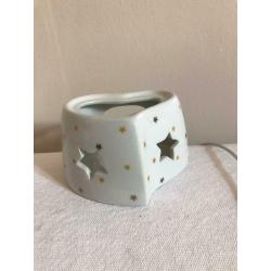 Tea light candle holder with cut out stars