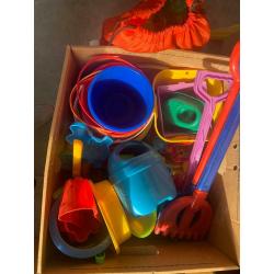 Box and bag overflowing with garden/ beach / seaside / water park toys