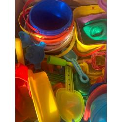 Box and bag overflowing with garden/ beach / seaside / water park toys