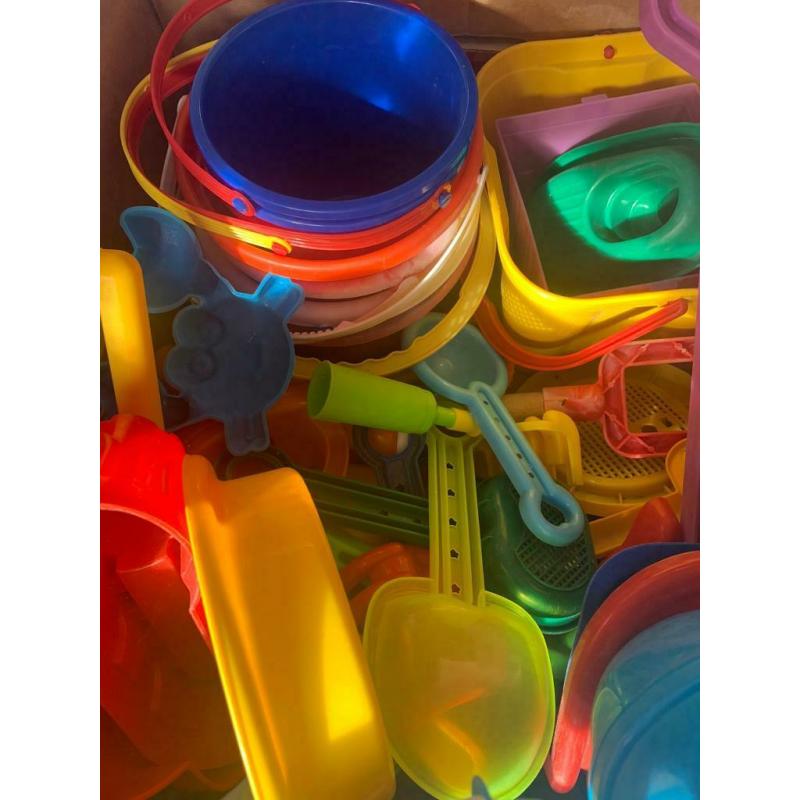 Box and bag overflowing with garden/ beach / seaside / water park toys