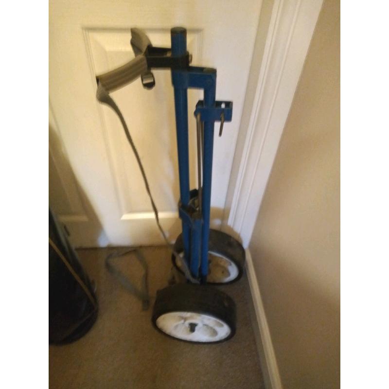 Set of golf clubs, bag and trolley.
