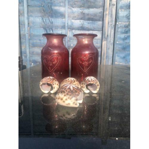 Tortoise shell napkins holders and red vases