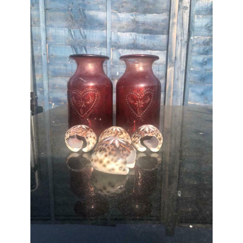 Tortoise shell napkins holders and red vases